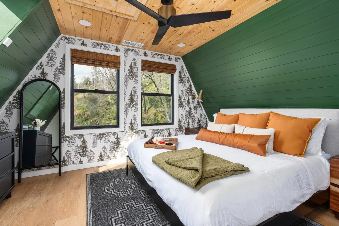 Primary suite with king bed and green shiplap walls