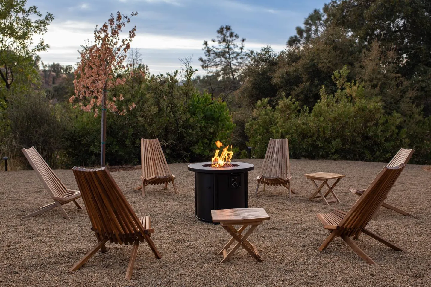 Gas fire pit with chairs overlooking the Sierra foothills at dusk
