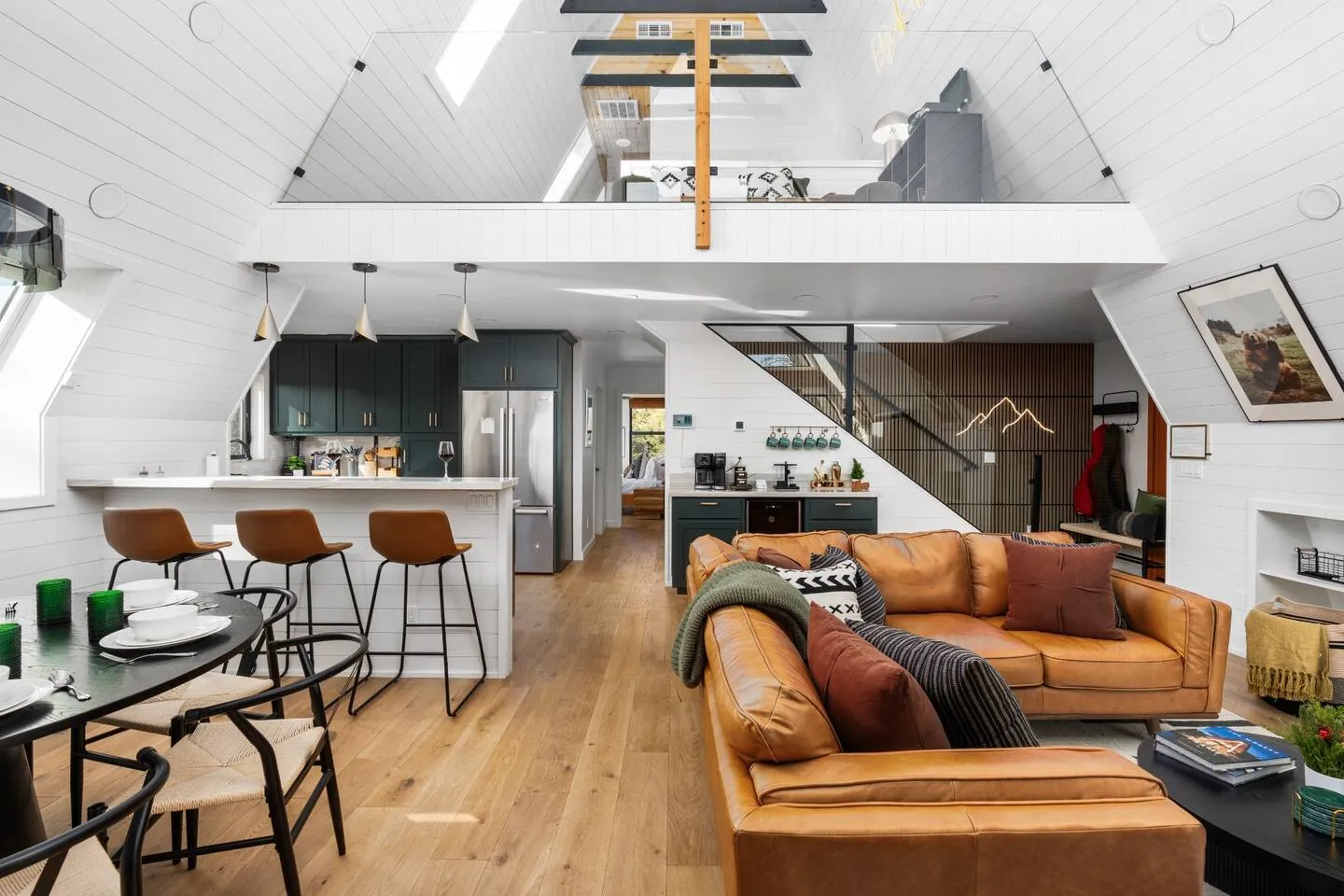 Open-concept great room with loft above