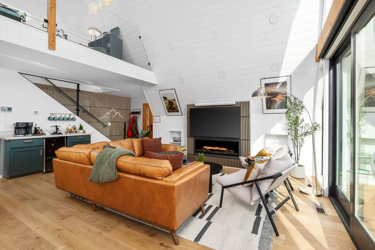 Living room with leather sofa, fireplace and 65-inch TV